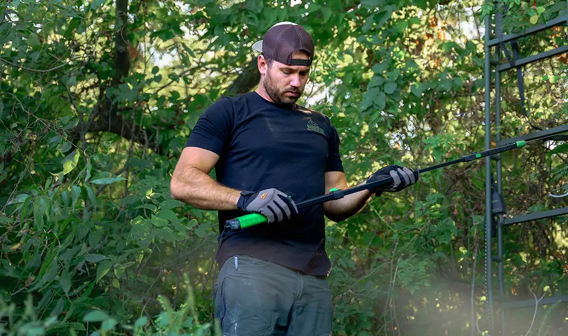 guy holding a tool for land management